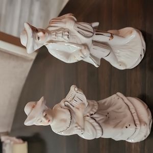 Vintage man and lady playing harp and violin.